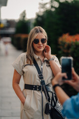 Influencer posing while being photographed outdoors