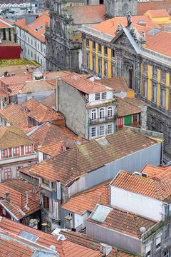 Old tiled rooftops and historic buildings in Porto, Portugal