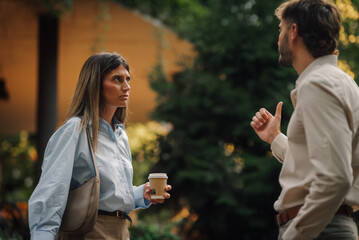 Businesspeople discussing outdoor during coffee break showing thumb up