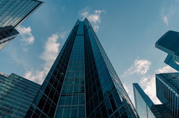bottom view of the tall skyscrapers of the business district of a modern city