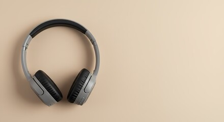 Overhead View of Gray Wireless Headphones on Beige Background