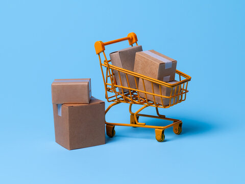 Cardboard boxes in a trolley on blue background,concept of online shopping and e-commerce transactions.