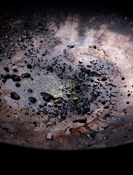 Closeup Gold on grungy wash pan with river sand. Gold digging discovery