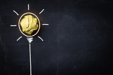 Idea with yellow crumpled paper ball ( lightbulb ) and businessman.Creative concept.