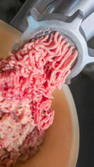Meat grinder with fresh minced meat on the kitchen table Close-up of minced meat