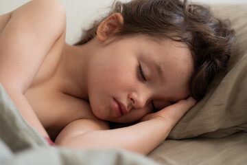 portrait of a girl of 3 years old sleeping sweetly on a pillow