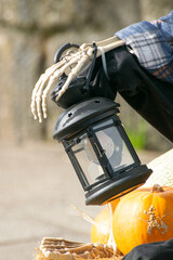 A Halloween Decoration with a Lantern and a Skeleton. Concept The light and shadow of horror.