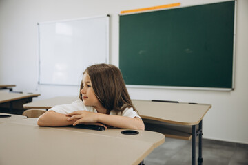 Thoughtful Girl Alone in Classroom
