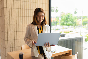 lifestyle of office workers Woman calculating expenses and using laptop. Home office. Work place....