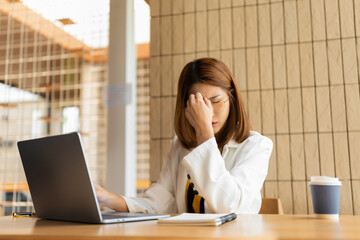 Serious businesswoman concentrating on his paper work at the table at office.