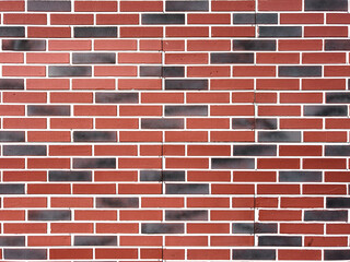 A brick wall with a red and black color pattern
