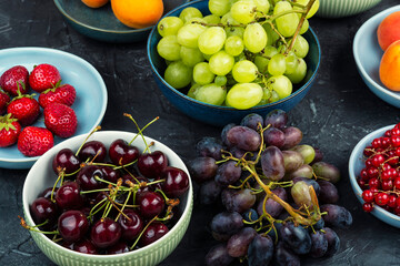 Fruits and berries in plate on table.