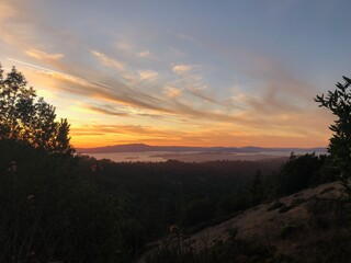 Golden Sunset Over Rolling Hills and Bay View