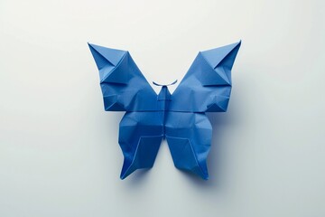 Blue origami butterfly created with precision and artistry on a white background showcasing the beauty of paper folding