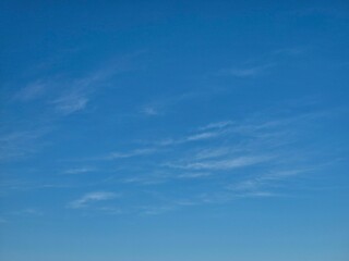 Clear blue sky with light wispy clouds on a bright sunny day