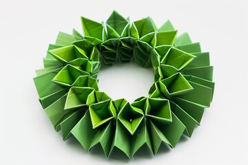 Intricate green origami wreath crafted from paper and showcasing meticulous folding techniques