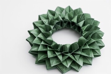 Origami wreath crafted with green paper showcasing intricate folds and textures for decorative purposes