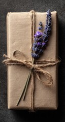 A kraft paper gift box tied with twine, adorned with a sprig of lavender