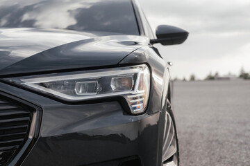 Premium electric SUV in gray with black chrome trim and large wheels.