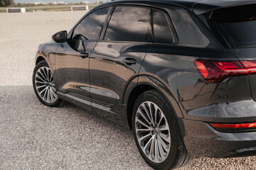 Premium electric SUV in gray with black chrome trim and large wheels.
