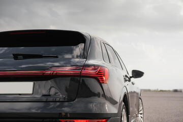 Premium electric SUV in gray with black chrome trim and large wheels.