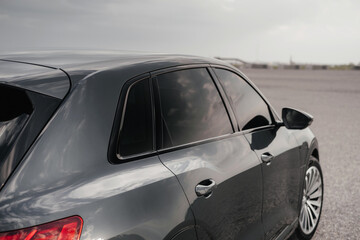 Premium electric SUV in gray with black chrome trim and large wheels.