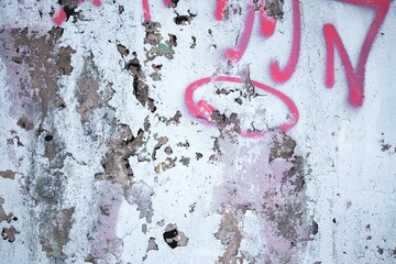 Peeling plaster wall with pink graffiti, showcasing urban grunge texture. 90s style, vibrant,...