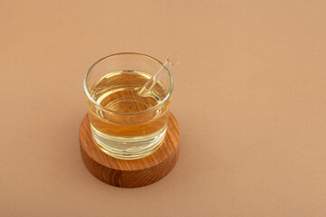 Food Additive E433. Polyoxyethylene (20) sorbitan monooleate or Polysorbate 80 in glass cup.  Emulsifier and stabilizer. Versatile additive used wherever water-oil mixing. Texture enhancer