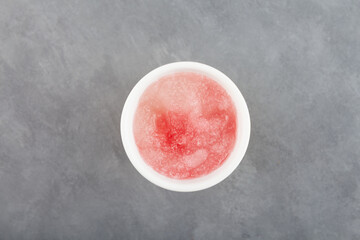 Spanish granizado, top view. Flavored Shaved Ice or Crushed ice with grapefruit juice or watermelon syrup beverage. Frozen Slush Drink. Refreshing summer drink