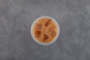 Ersatz coffee or Chicory iced coffee. Iced chicory latte in disposable plastic cup, top view. Refreshing cold drink. Take away street food drink