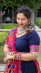 Indian woman in traditional Navratri attire, adorned with colorful bangles, mirror work dupatta,...