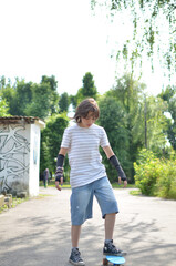 A teenage girl on a skateboard is riding and listening to music through headphones.