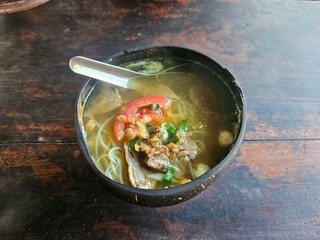 Traditional meat soup with steaming broth, beef, and herbs, captured overhead in an isolated setup to showcase cultural cuisine and recipe illustration