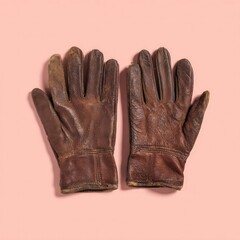 Pair Of Worn Brown Leather Gloves On A Pastel Pink Background