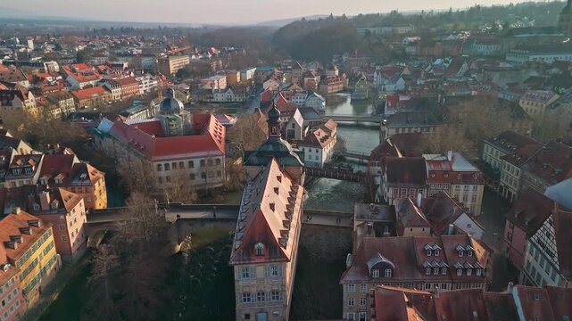 Aerial view of the Altes Rathaus, the historic Old Town Hall standing proudly on a bridge over the Regnitz River, Bamberg, Bavaria, Germany.
