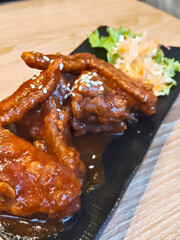 Close-up of Spicy Chicken Wings with Salad