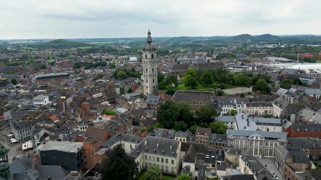 Aerial view of Belfry of Mons, with its intricate stonework, towering over the city's rooftops, a blend of history and architectural grandeur, Mons, Belgium.