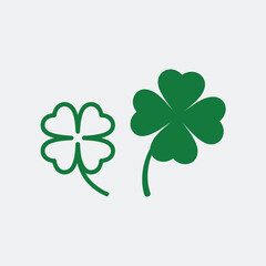 Two green four leaf clover symbols on a light gray background