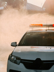 Emergency vehicle responding to a call in a residential area during early morning light