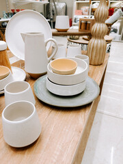 Modern ceramic tableware displayed in a store setting with elegant design elements