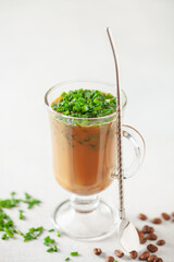 Chinese scallion coffee latte. Cold iced coffee with fresh spring onions in glass
