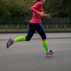 woman running marathon in long sleeve, leggings and compression socks