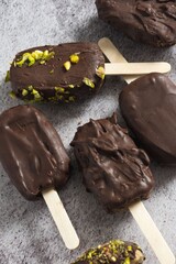 Chocolate ice cream bars with pistachio topping.