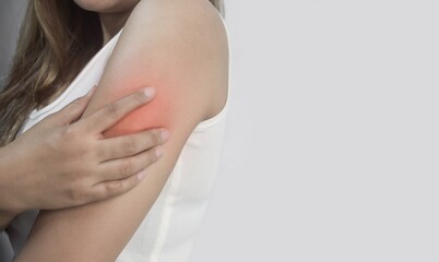 Young Woman Experiencing Arm Pain with Red Highlighted Area