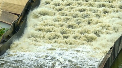 Bird's eye view showing the Water Transfer Bridge channeling floodwater over canals and roads, using a flume and pumps to speed water discharge to the sea, helping to minimize flooding impact.
