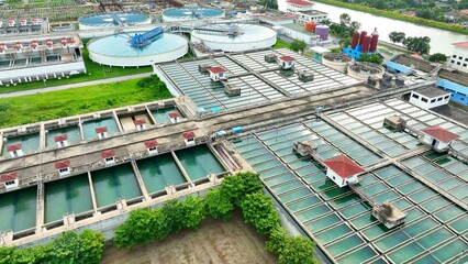 Aerial drone view of a wastewater treatment plant showing large clarifiers and filtration tanks, highlighting advanced infrastructure for sustainable water management and environmental protection.

