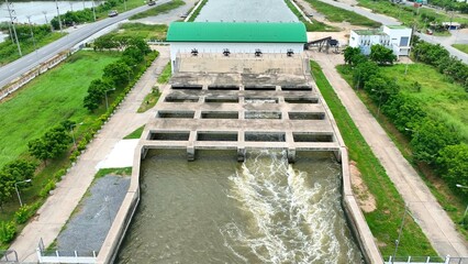 A pumping station moves water to the Water Transfer Bridge, enabling efficient drainage and preventing flooding by directing excess water safely to the sea. Thailand. Aerial view. 
