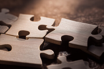 Wooden puzzle pieces lying on a table