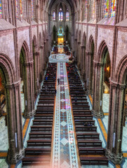 Interior of the Basilica of the National Vow in Neo Gothic style with its colorful stained glass windows.