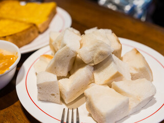 Close up of slice steamed bread on white dish.